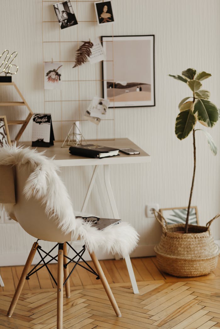 A stylish home office with a furry chair, sleek desk, and minimalist decor, creating a cozy and productive workspace.